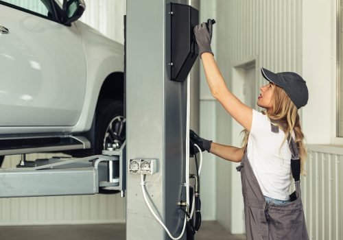young-woman-service-employee-lifting-car (1)